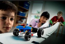 children testing lego car model